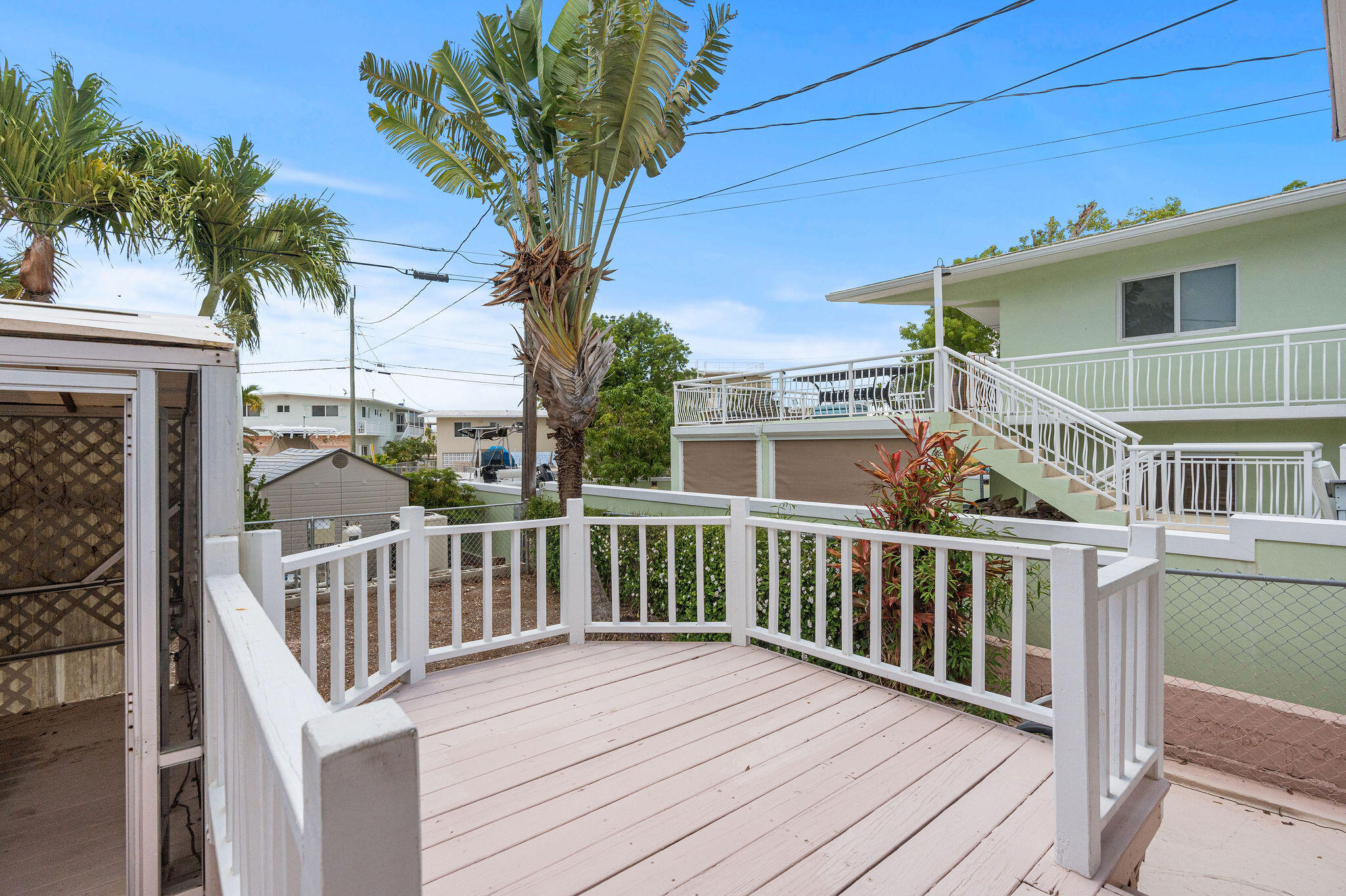 412 3rd Street Key Largo, FL 33037 - Photo 26 of 41 a view of a deck with two chair and wooden floor