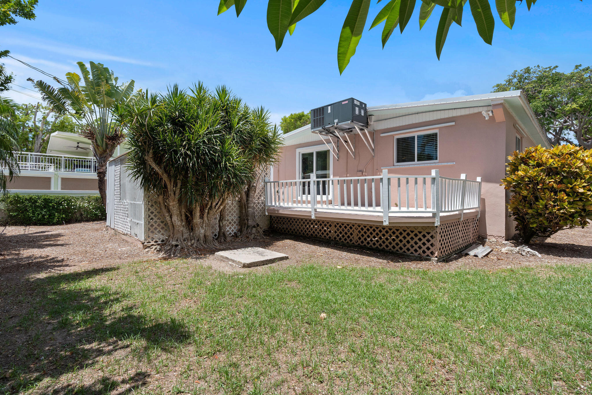 412 3rd Street Key Largo, FL 33037 - Photo 29 of 41 a view of a house with a yard and a garden