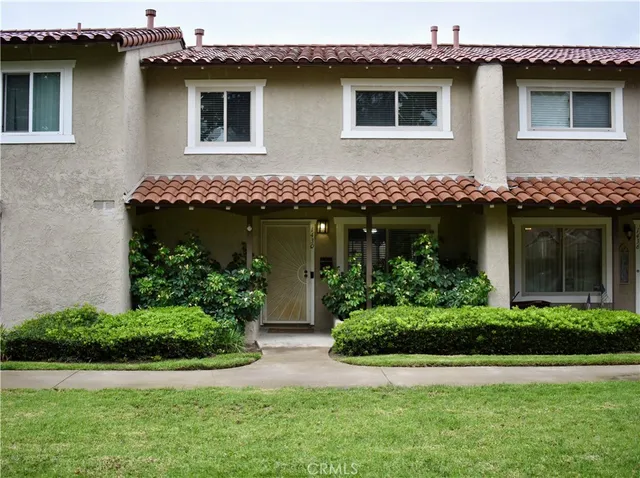 a front view of a house with lots of green space