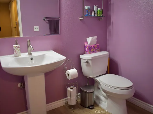a white toilet sitting next to a bathroom sink