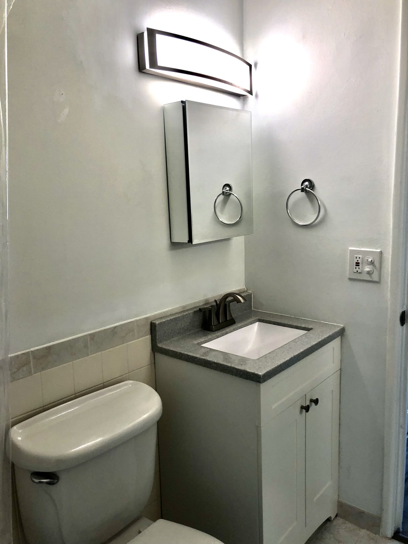 3523 Central Road, Unit 302 Glenview, IL 60025 - Photo 8 of 8 a bathroom with a granite countertop toilet sink and mirror