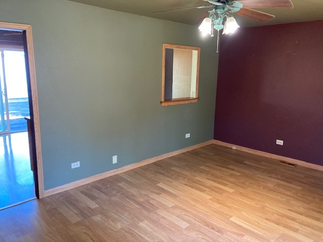 22201 Rockingham Road Richton Park, IL 60471 - Photo 6 of 18 a view of an empty room with wooden floor and a window
