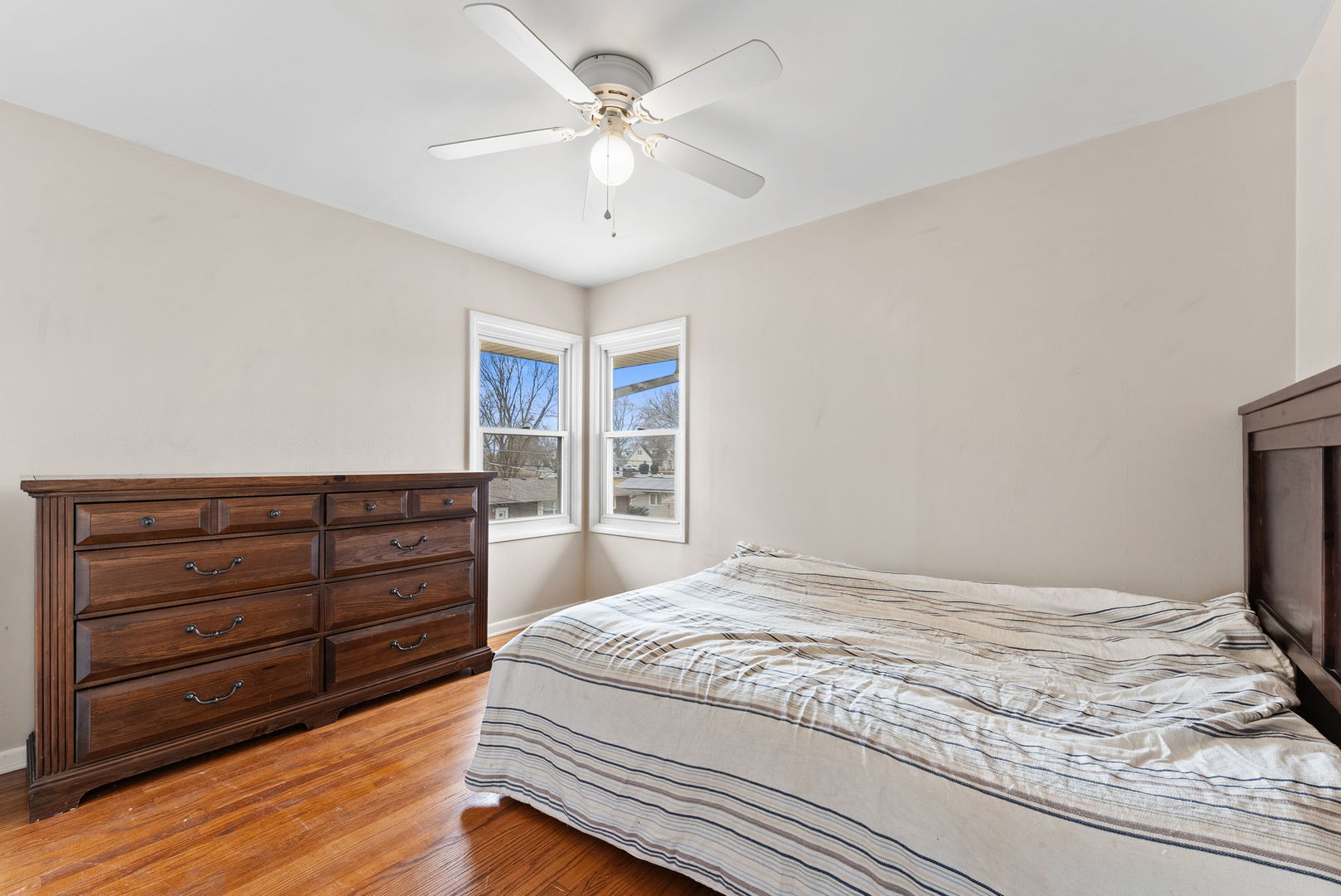1135 5th Avenue North Clinton, IA 52732 - Photo 13 of 22 a bedroom with a bed and a chandelier