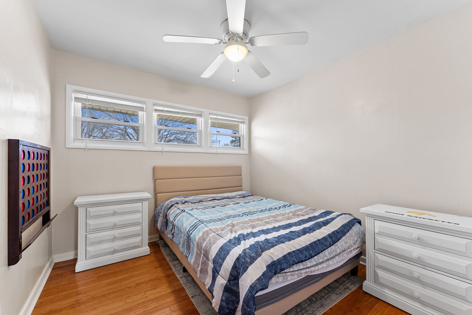 1135 5th Avenue North Clinton, IA 52732 - Photo 14 of 22 a bedroom with a bed and a chandelier