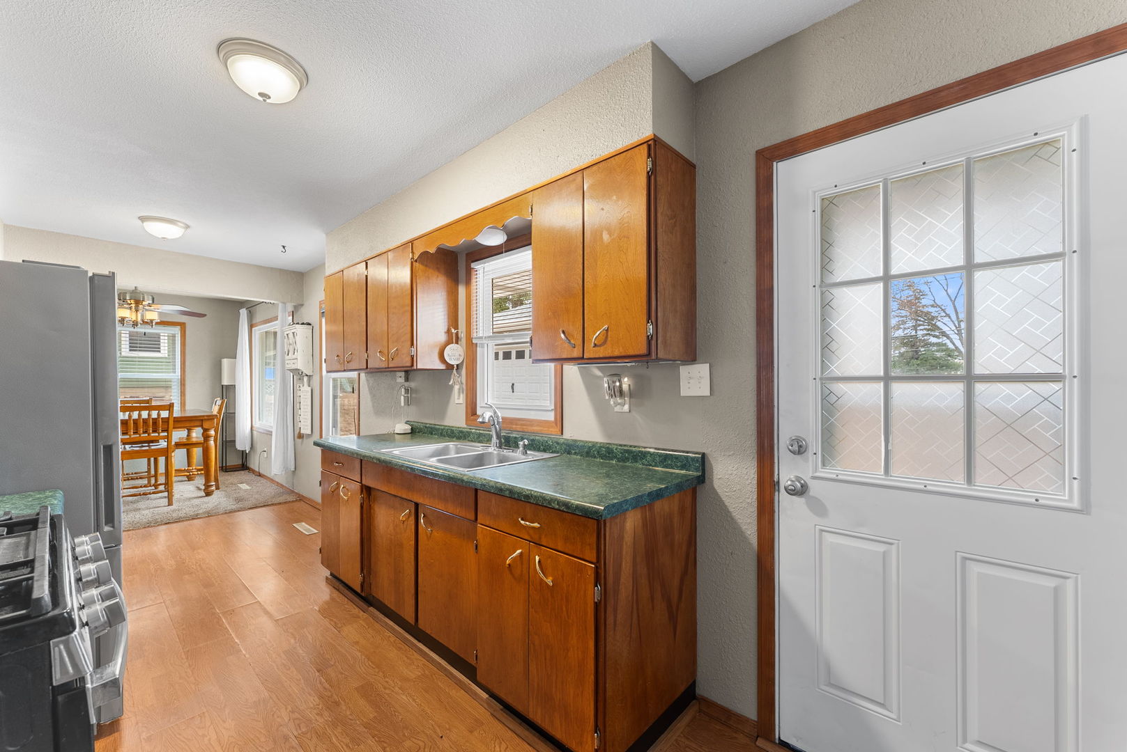 1135 5th Avenue North Clinton, IA 52732 - Photo 10 of 22 a kitchen with stainless steel appliances granite countertop a stove a sink and a refrigerator