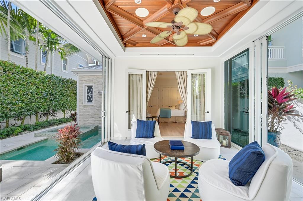 42 6th Street South Naples, FL 34102 - Photo 11 of 46 View of patio featuring a ceiling fan