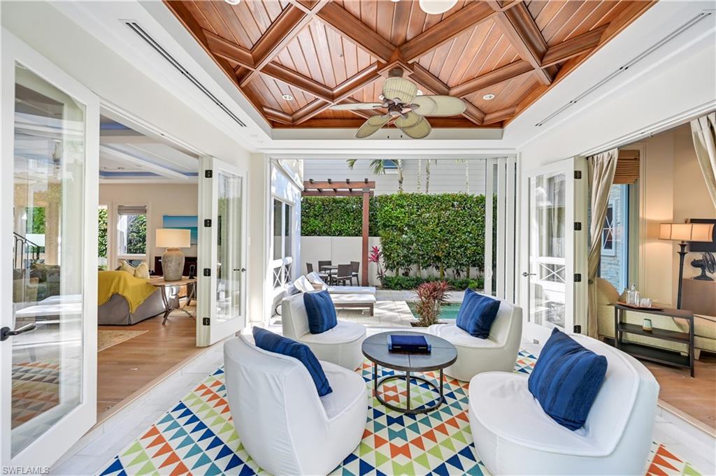 42 6th Street South Naples, FL 34102 - Photo 16 of 46 Sunroom with coffered ceiling, wooden ceiling, french doors, and crown molding