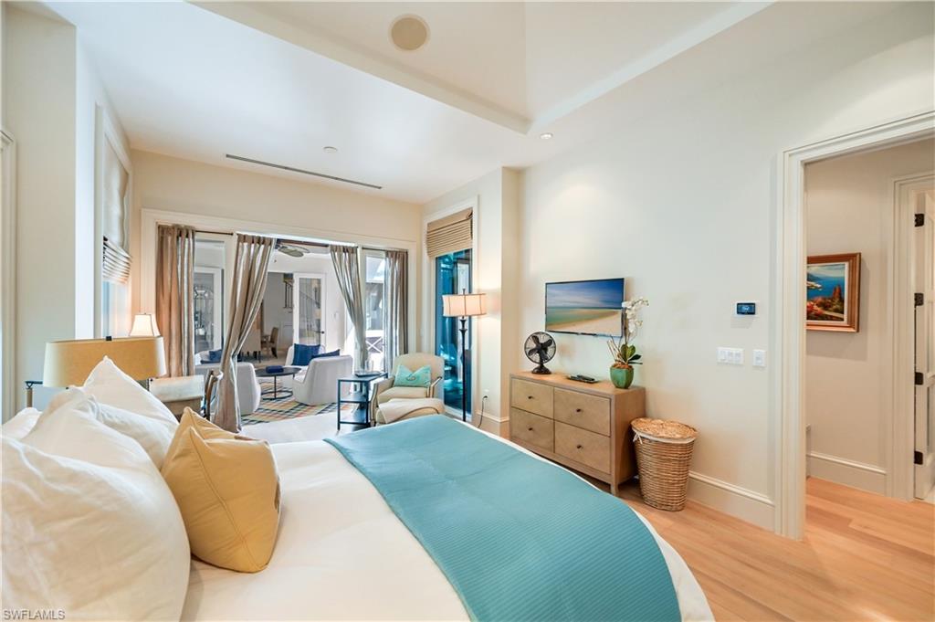 42 6th Street South Naples, FL 34102 - Photo 18 of 46 Bedroom featuring light wood finished floors, recessed lighting, and access to outside