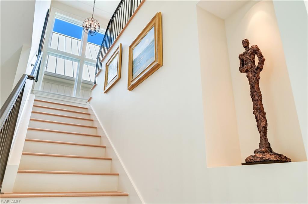 42 6th Street South Naples, FL 34102 - Photo 29 of 46 Stairway with a high ceiling and suspended lighting