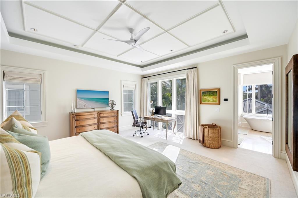 42 6th Street South Naples, FL 34102 - Photo 32 of 46 Bedroom featuring a raised ceiling, ceiling fan, and an office area