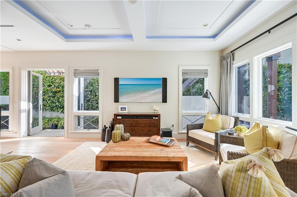 42 6th Street South Naples, FL 34102 - Photo 6 of 46 Living room with wood finished floors and a raised ceiling