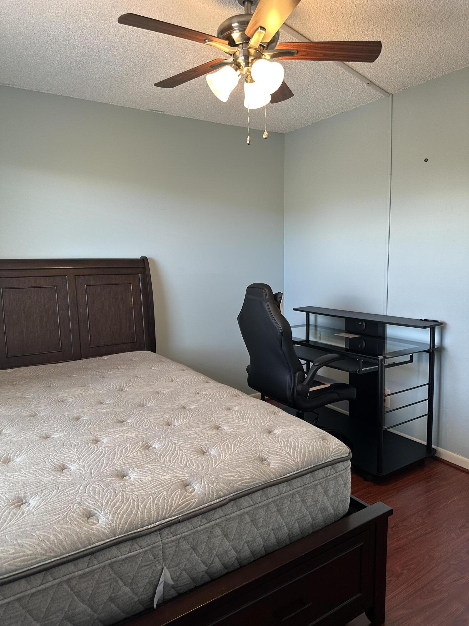 9355 Southwest 8th Street, Unit 311 Boca Raton, FL 33428 - Photo 11 of 17 a bedroom with a bed and wooden floor