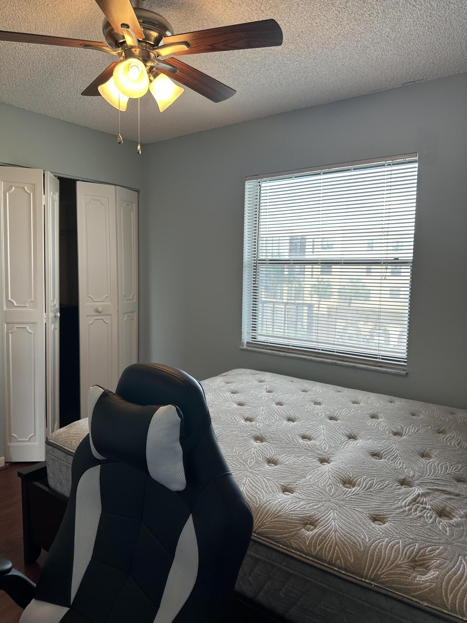 9355 Southwest 8th Street, Unit 311 Boca Raton, FL 33428 - Photo 12 of 17 a bedroom with a bed and a window