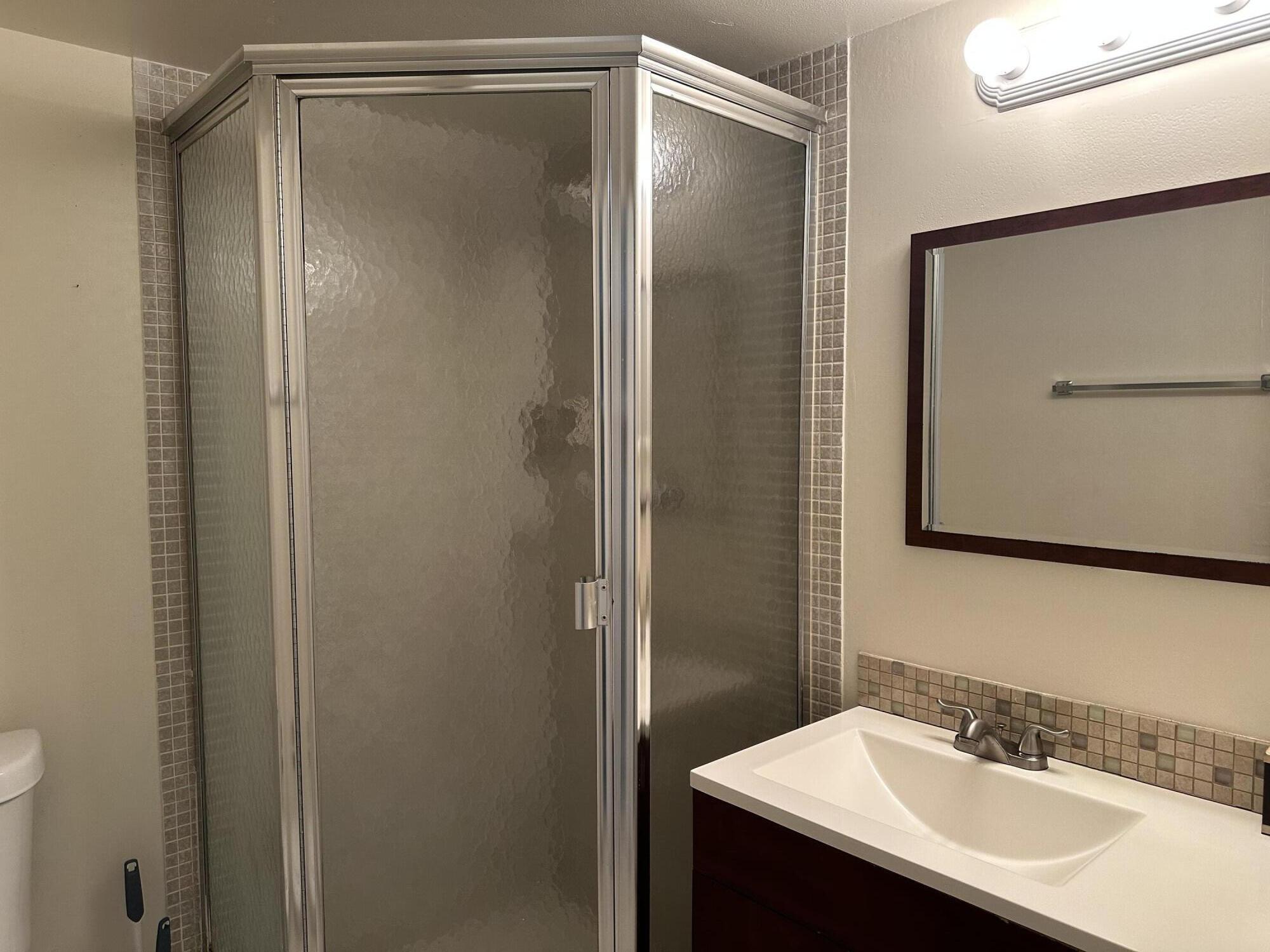 9355 Southwest 8th Street, Unit 311 Boca Raton, FL 33428 - Photo 15 of 17 a bathroom with a sink and mirror