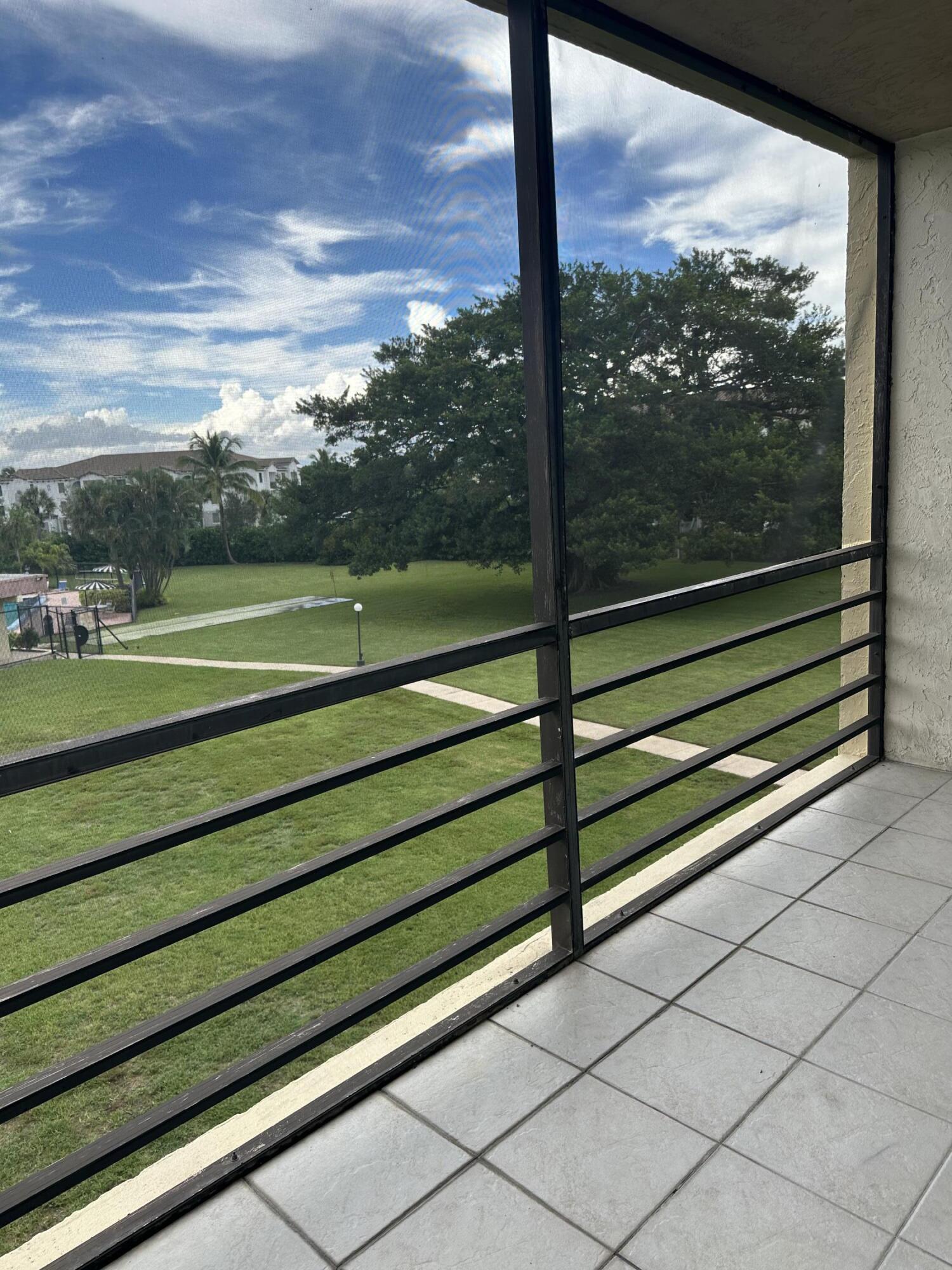9355 Southwest 8th Street, Unit 311 Boca Raton, FL 33428 - Photo 16 of 17 a view of outdoor space with wooden floor and fence