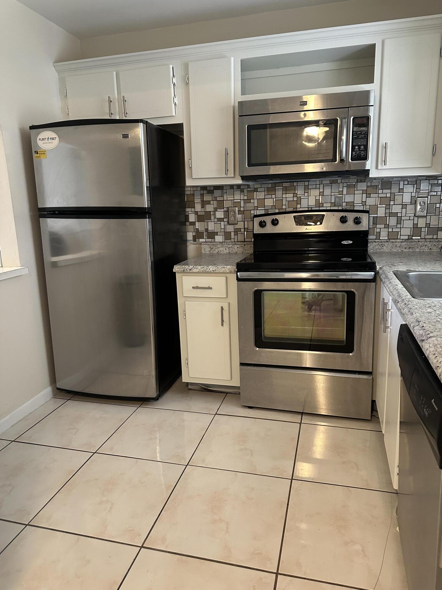 9355 Southwest 8th Street, Unit 311 Boca Raton, FL 33428 - Photo 2 of 17 a kitchen with appliances and cabinets