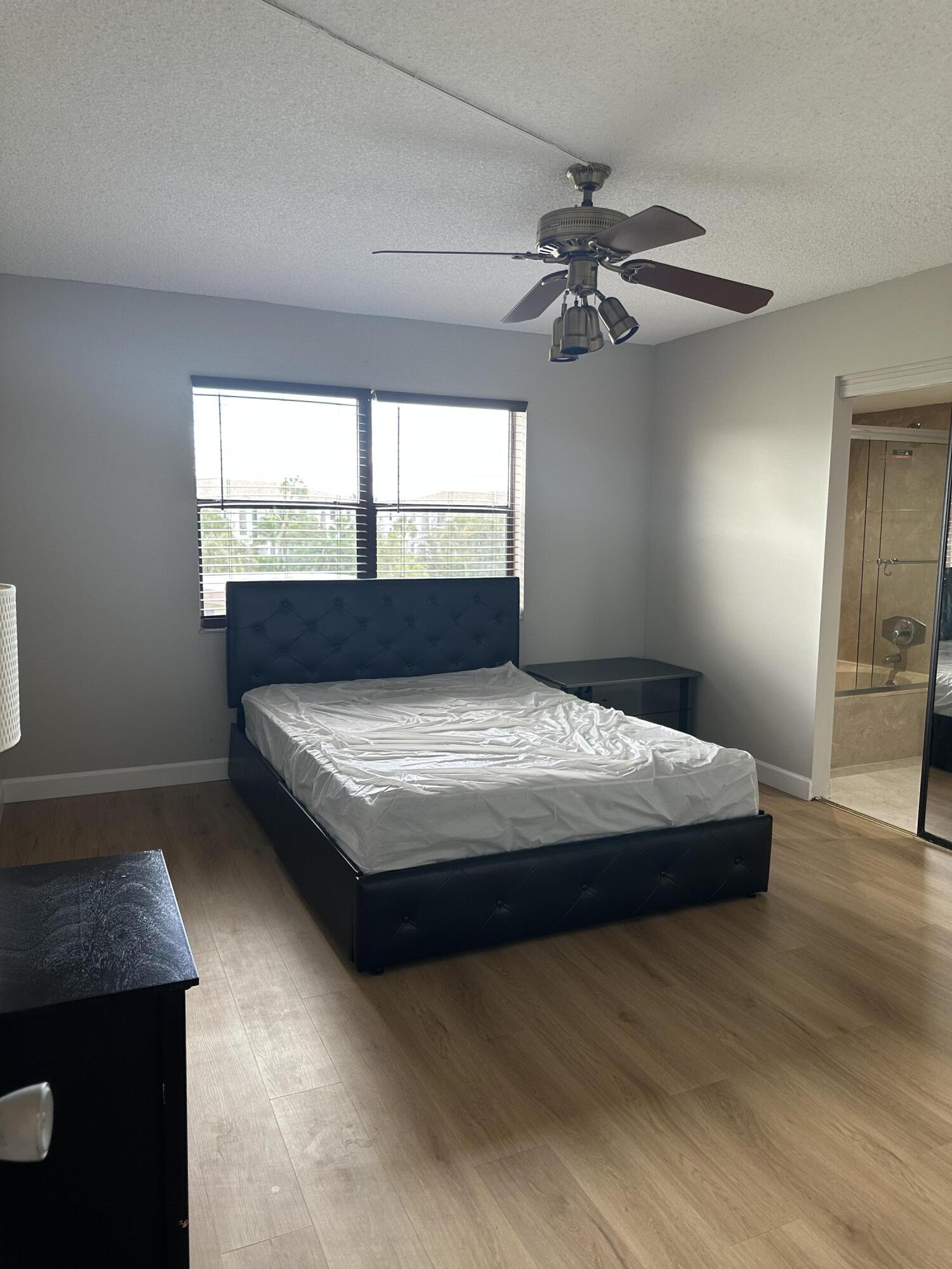 9355 Southwest 8th Street, Unit 311 Boca Raton, FL 33428 - Photo 6 of 17 a bedroom with a bed and window