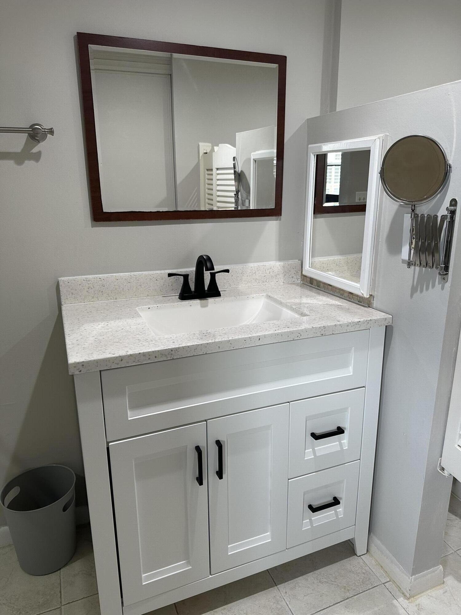 9355 Southwest 8th Street, Unit 311 Boca Raton, FL 33428 - Photo 8 of 17 a bathroom with a sink and a mirror
