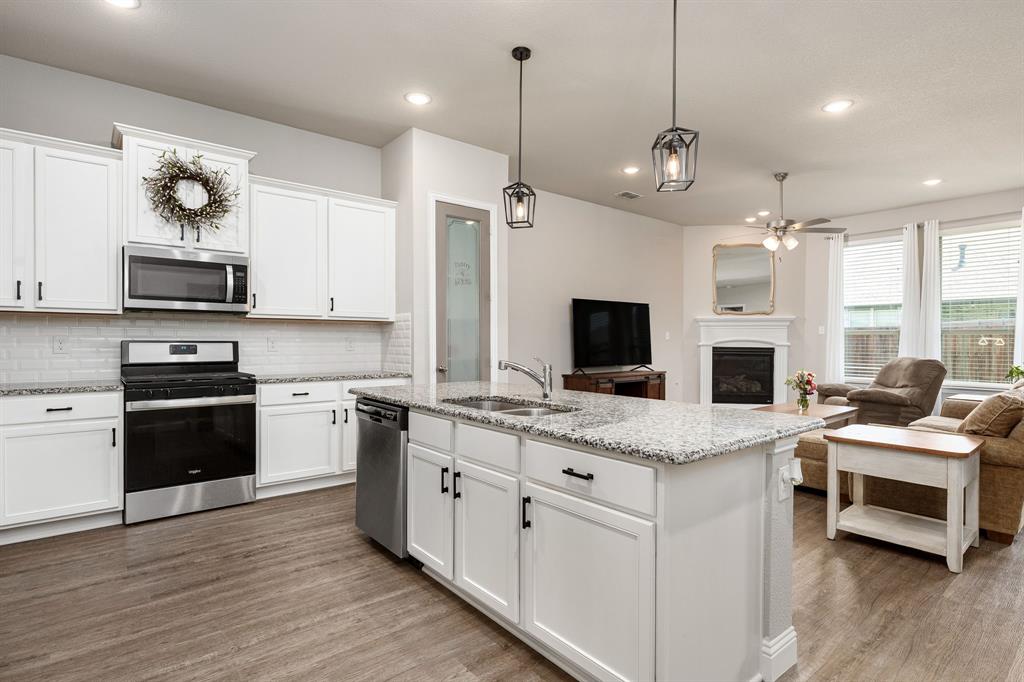 1320 Rosebush Road Aubrey, TX 76227 - Photo 8 of 33 a kitchen with a sink stove and microwave