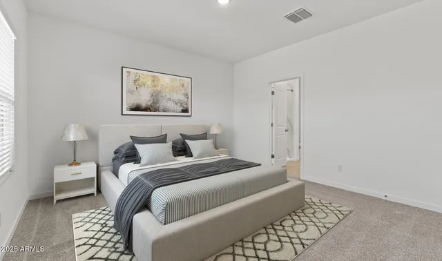 a bedroom with a bed and a lamp