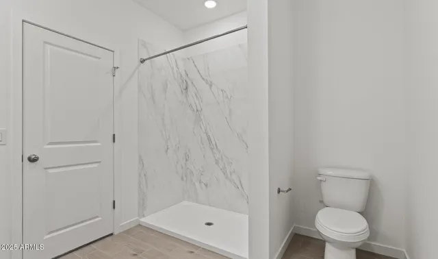 a bathroom with a shower and a toilet