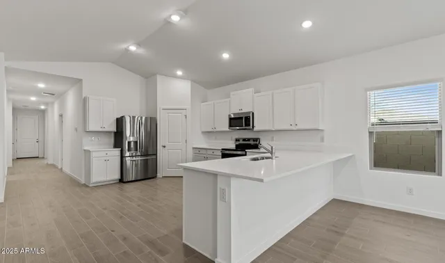 a kitchen with a refrigerator stove top oven and sink