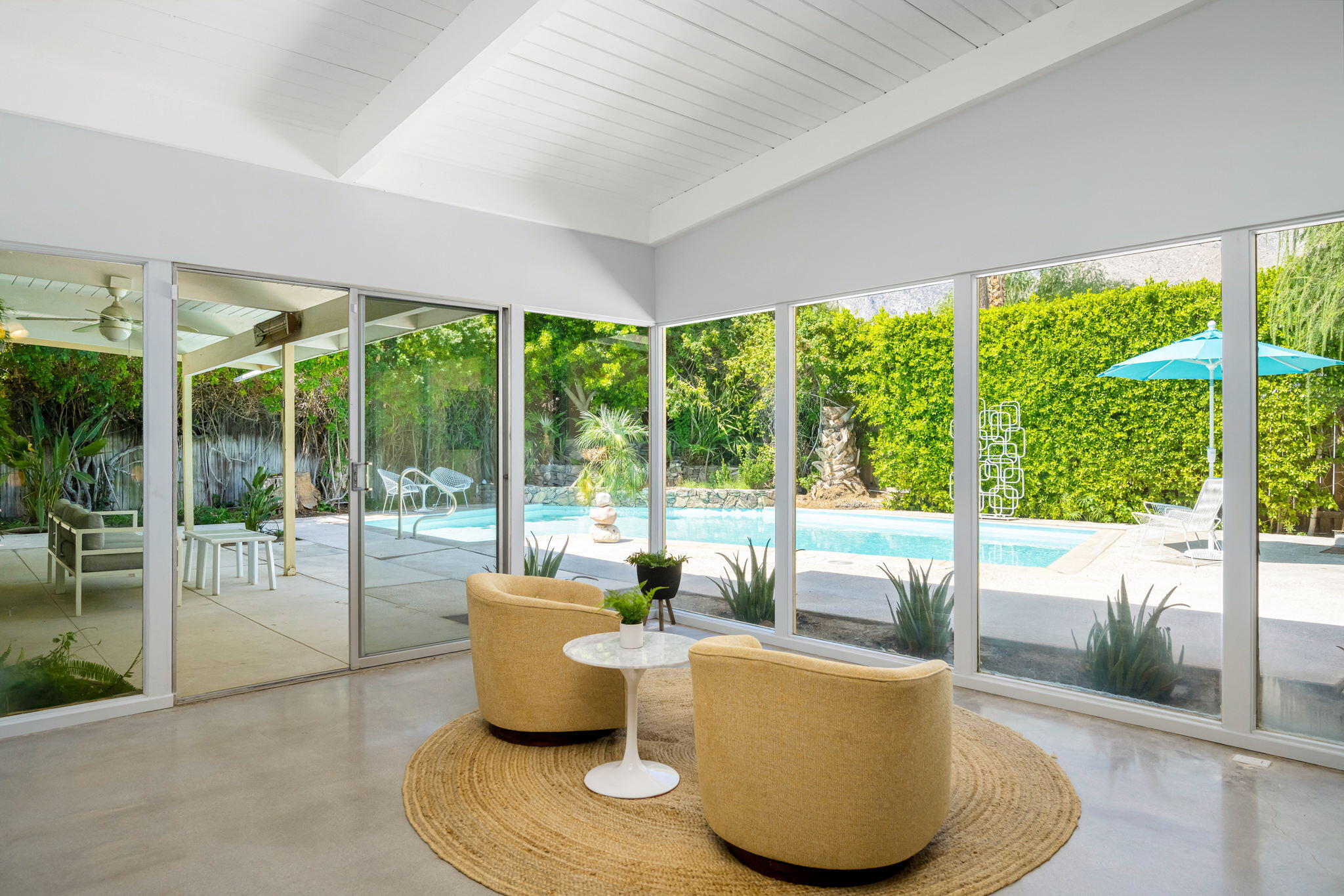 1333 East Deepwell Road Palm Springs, CA 92264 - Photo 13 of 44 a living room with furniture and a floor to ceiling window