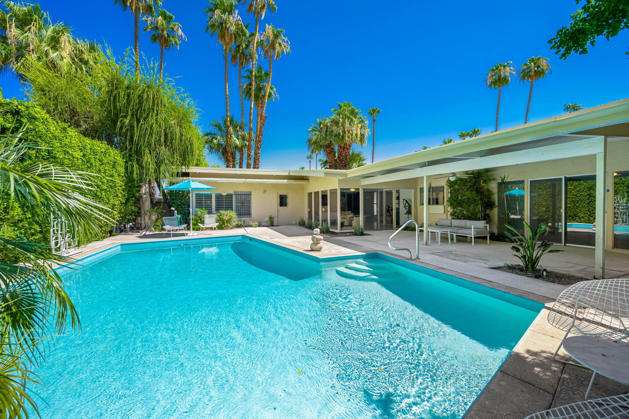 1333 East Deepwell Road Palm Springs, CA 92264 - Photo 17 of 44 a view of a house with a swimming pool