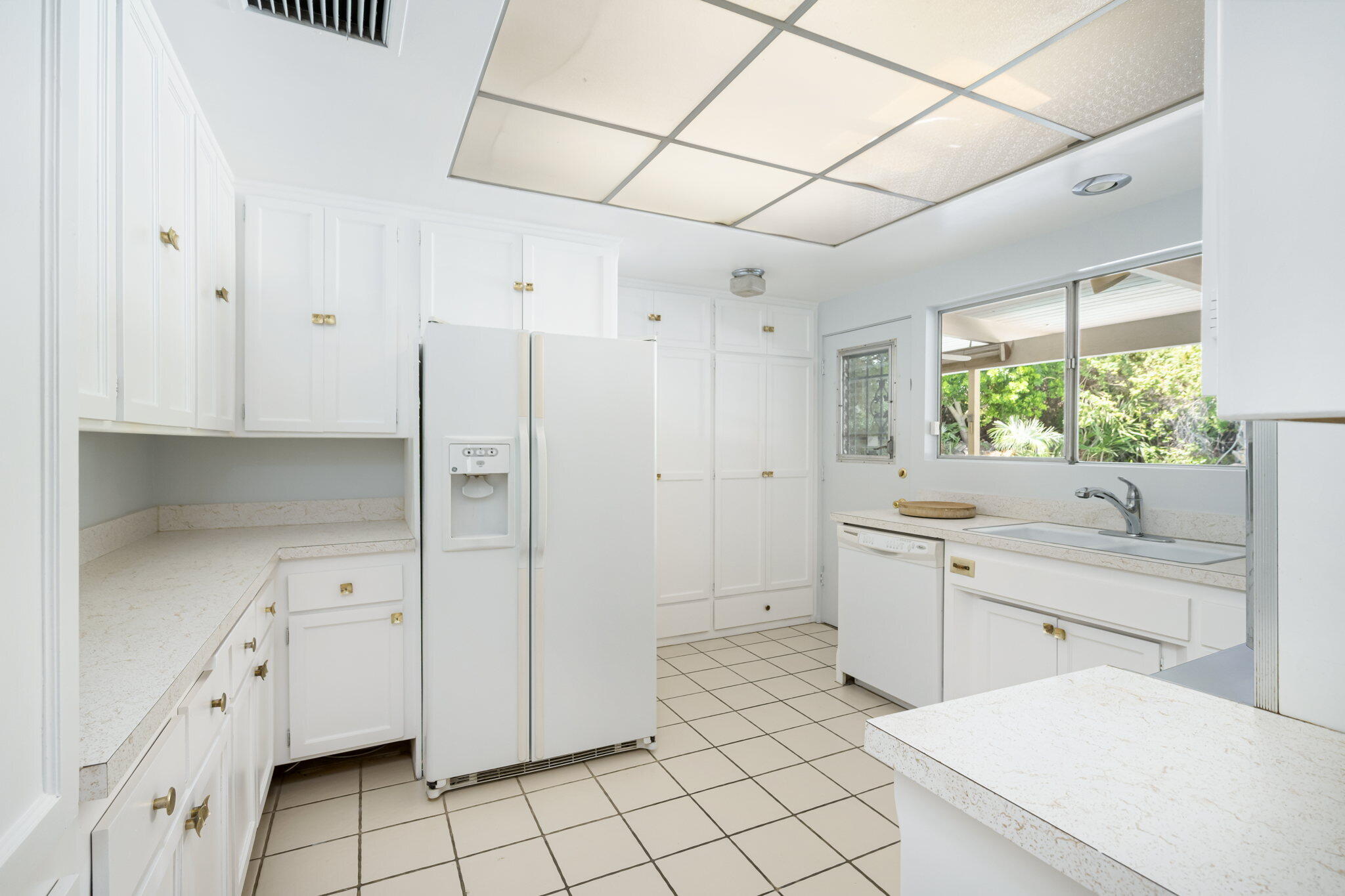 1333 East Deepwell Road Palm Springs, CA 92264 - Photo 28 of 44 a kitchen with white cabinets and white appliances