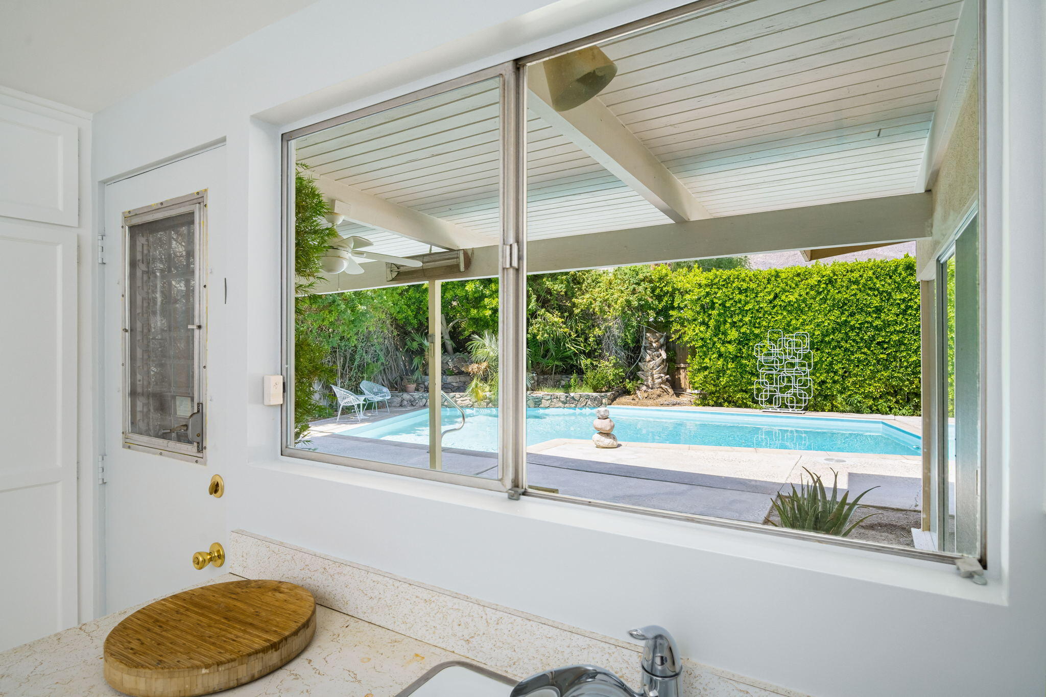 1333 East Deepwell Road Palm Springs, CA 92264 - Photo 30 of 44 a view of a room that has a bed and a table in it