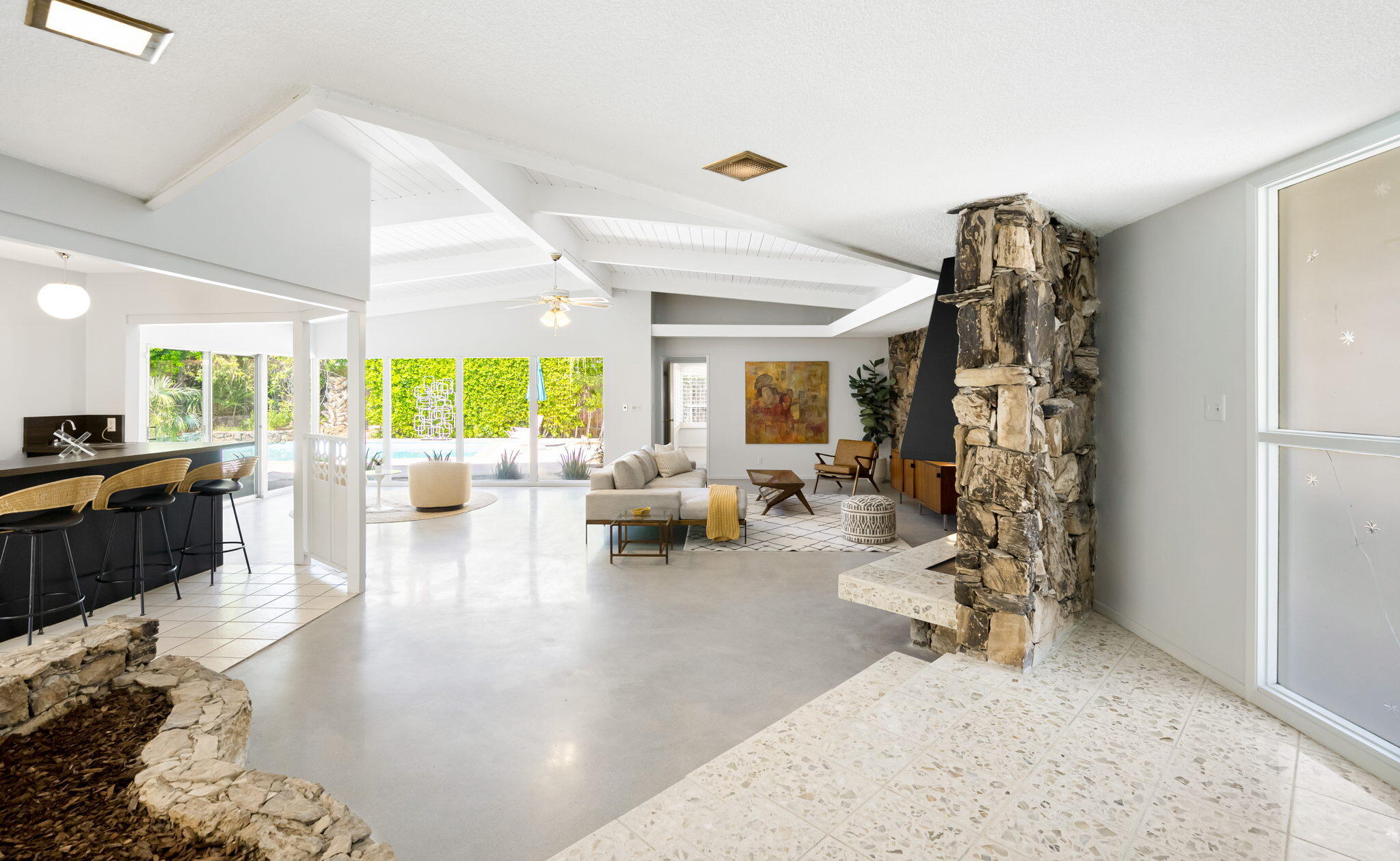 1333 East Deepwell Road Palm Springs, CA 92264 - Photo 3 of 44 a living room with furniture large window and view of kitchen