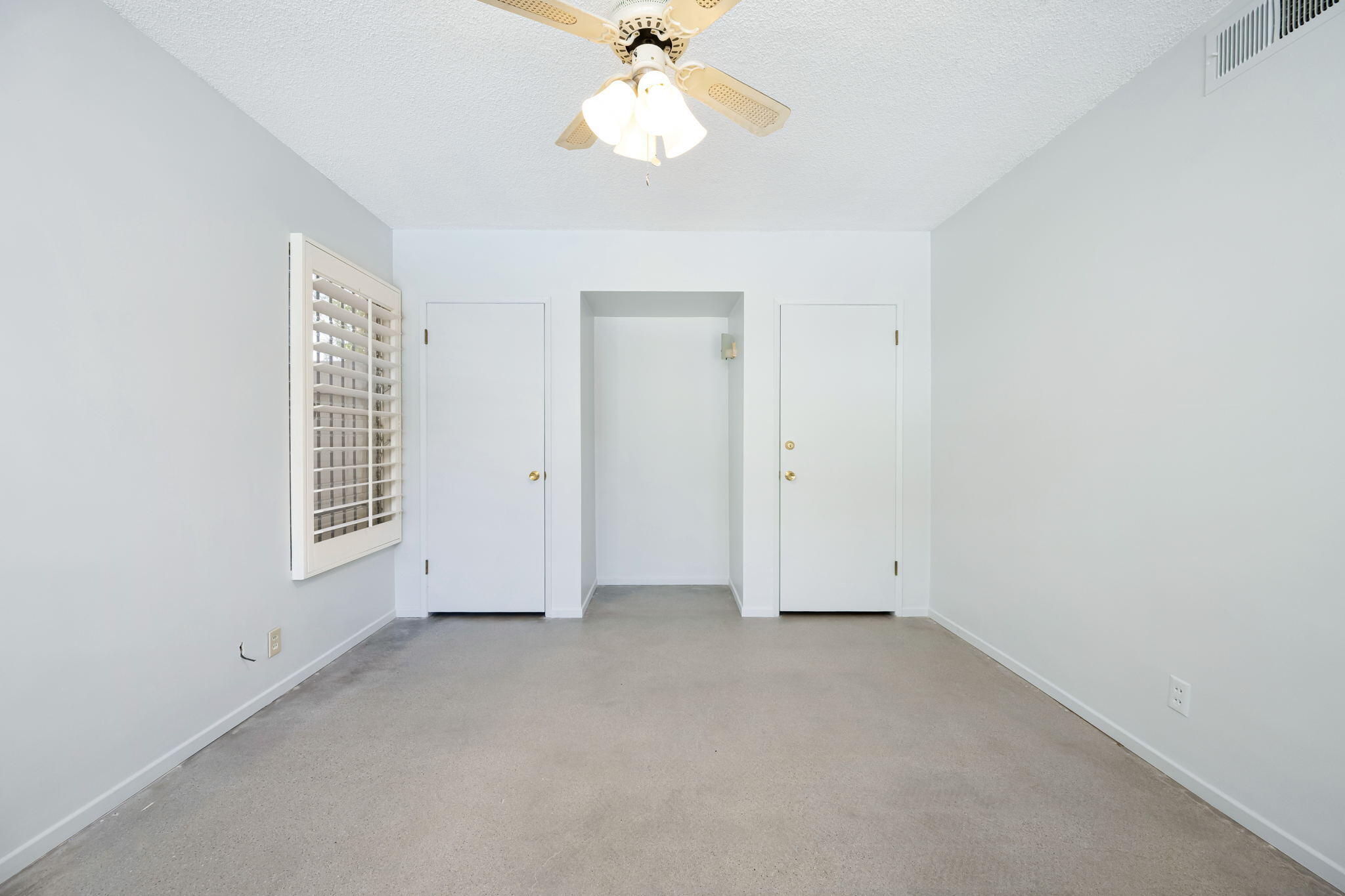 1333 East Deepwell Road Palm Springs, CA 92264 - Photo 35 of 44 an empty room with a window and a ceiling fan