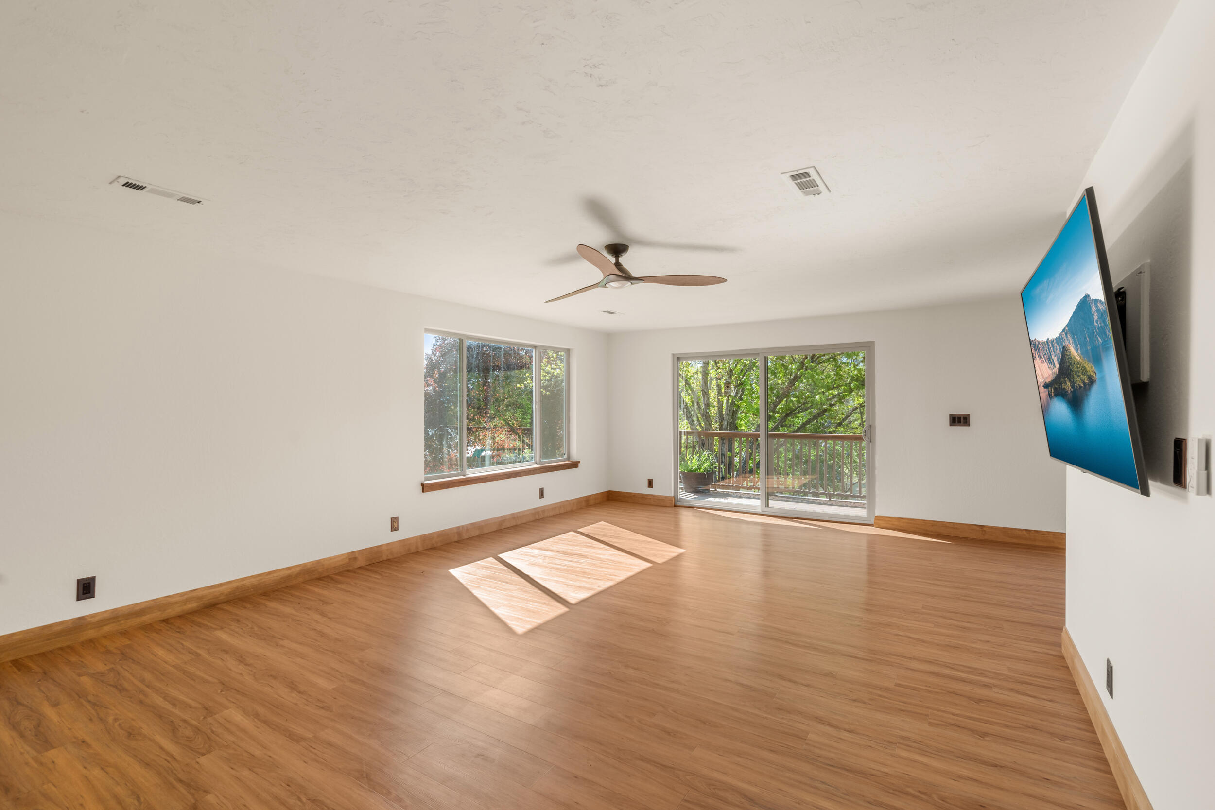 3583 Ross Lane Central Point, OR 97502 - Photo 7 of 52 an empty room with wooden floor and windows