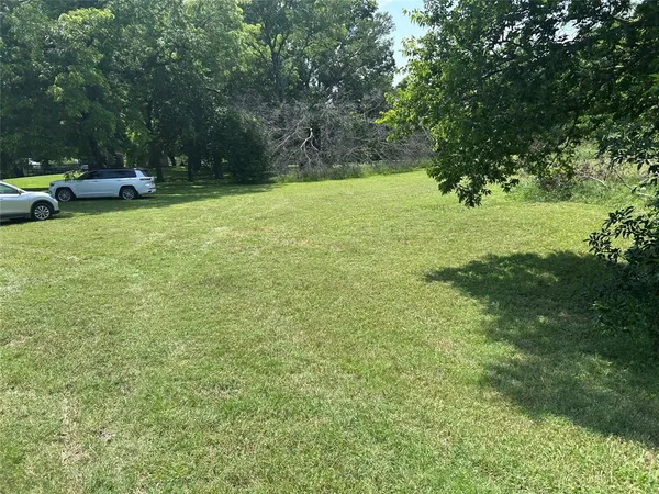 a view of a field with sitting area