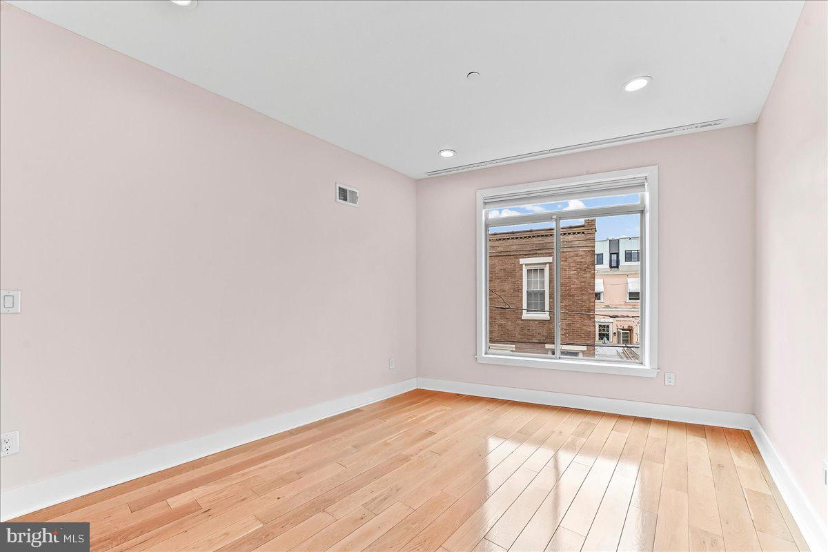 2615 East Letterly Street Philadelphia, PA 19125 - Photo 13 of 36 a view of an empty room with wooden floor and a window