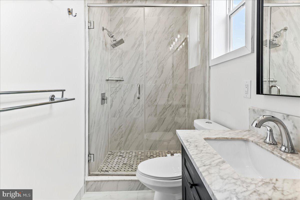2615 East Letterly Street Philadelphia, PA 19125 - Photo 24 of 36 a bathroom with a granite countertop sink toilet and shower