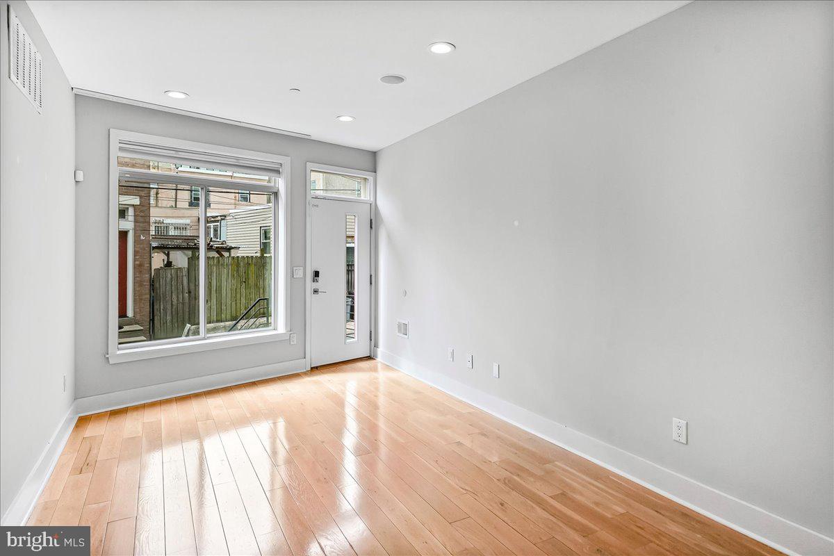 2615 East Letterly Street Philadelphia, PA 19125 - Photo 5 of 36 a view of an empty room with a window