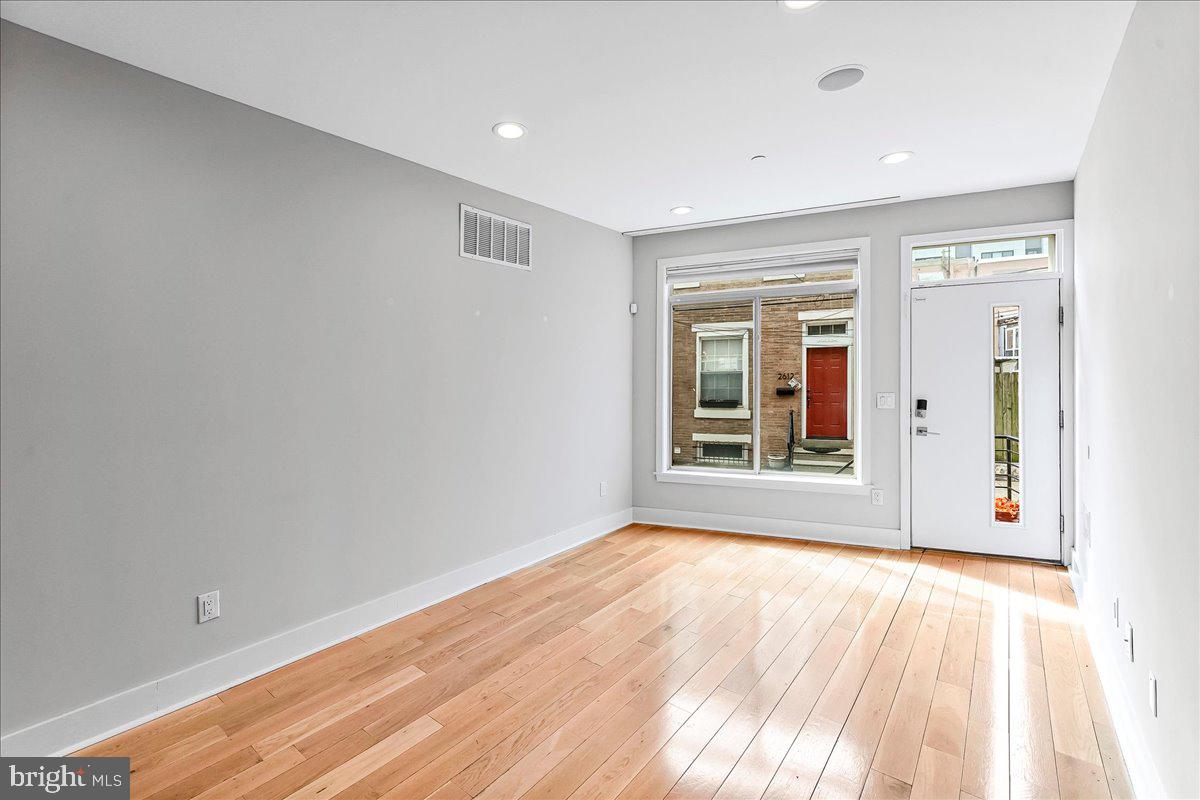 2615 East Letterly Street Philadelphia, PA 19125 - Photo 6 of 36 a view of an empty room with wooden floor and a window