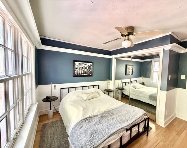 720 South New Street Champaign, IL 61820 - Photo 31 of 73 a bedroom with a bed and a large mirror with a wooden floor