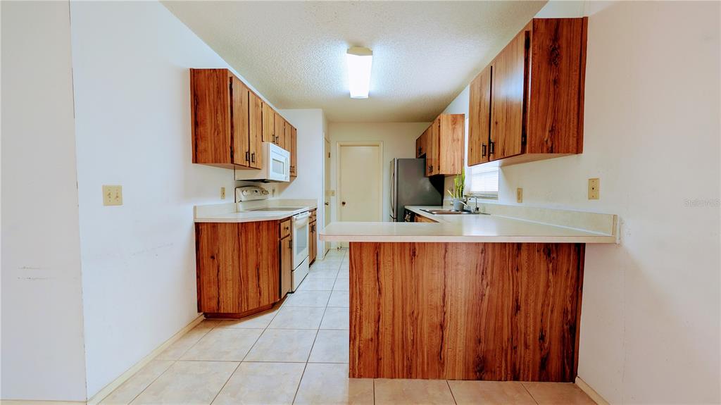 11438 Palomar Street Spring Hill, FL 34609 - Photo 14 of 37 a kitchen with stainless steel appliances granite countertop a granite counter tops and a cabinets