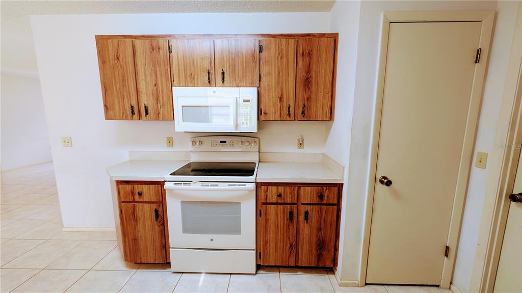 11438 Palomar Street Spring Hill, FL 34609 - Photo 17 of 37 a kitchen with a stove and a refrigerator