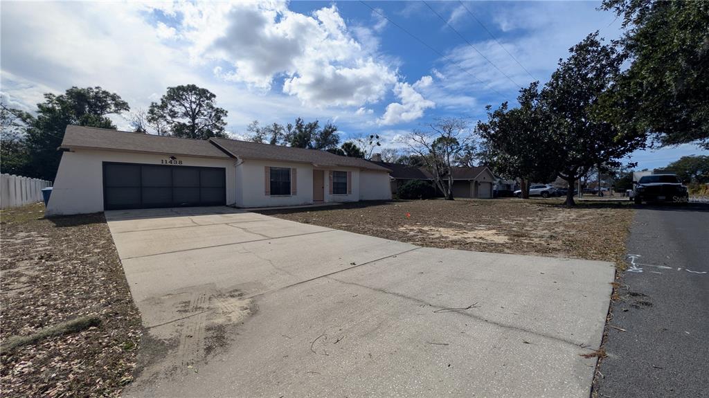 11438 Palomar Street Spring Hill, FL 34609 - Photo 2 of 37 a view of a house with a yard