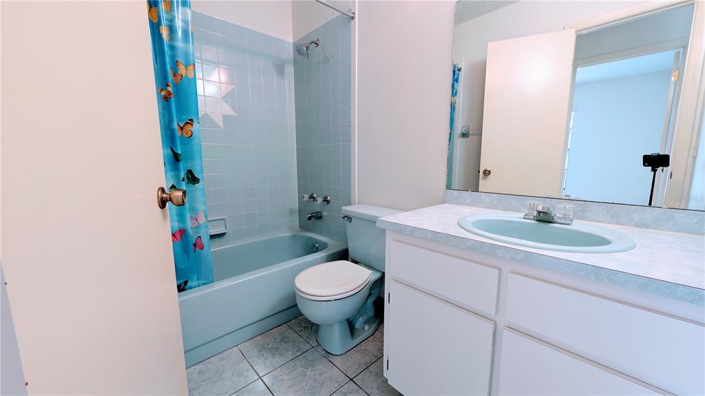 11438 Palomar Street Spring Hill, FL 34609 - Photo 23 of 37 a bathroom with a sink toilet and a mirror