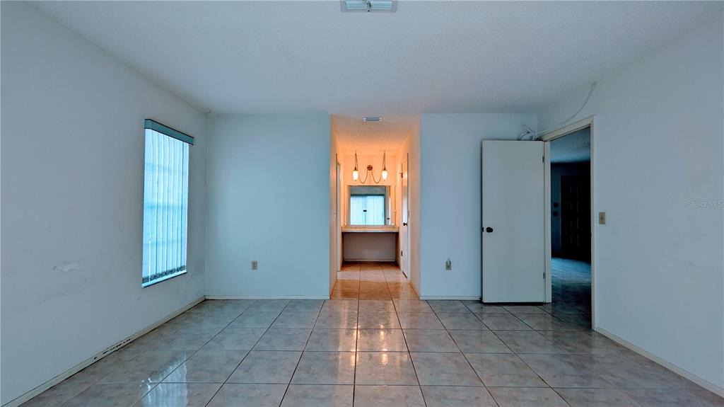 11438 Palomar Street Spring Hill, FL 34609 - Photo 28 of 37 an empty room with windows and closet