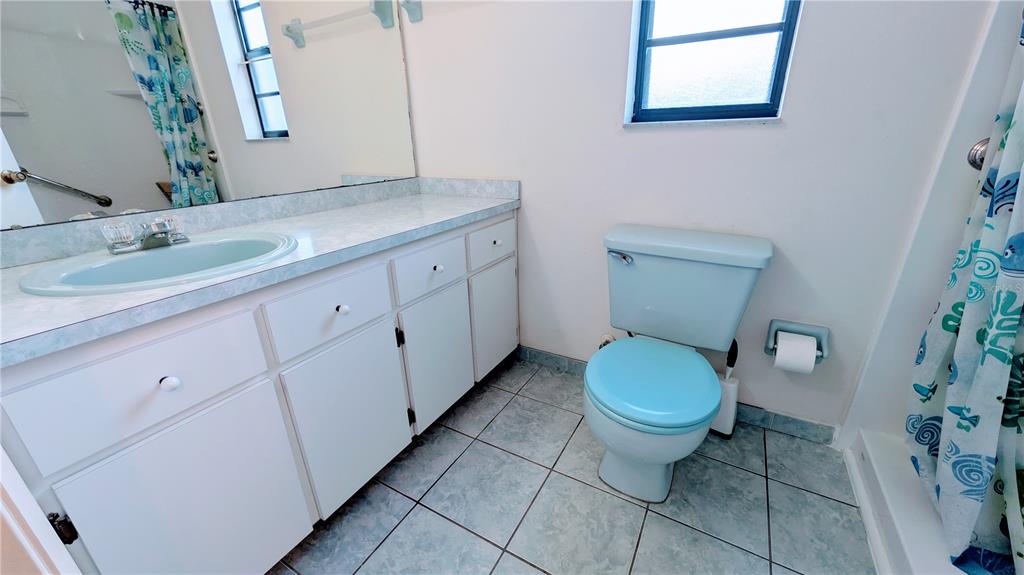 11438 Palomar Street Spring Hill, FL 34609 - Photo 29 of 37 a bathroom with a granite countertop toilet sink and mirror