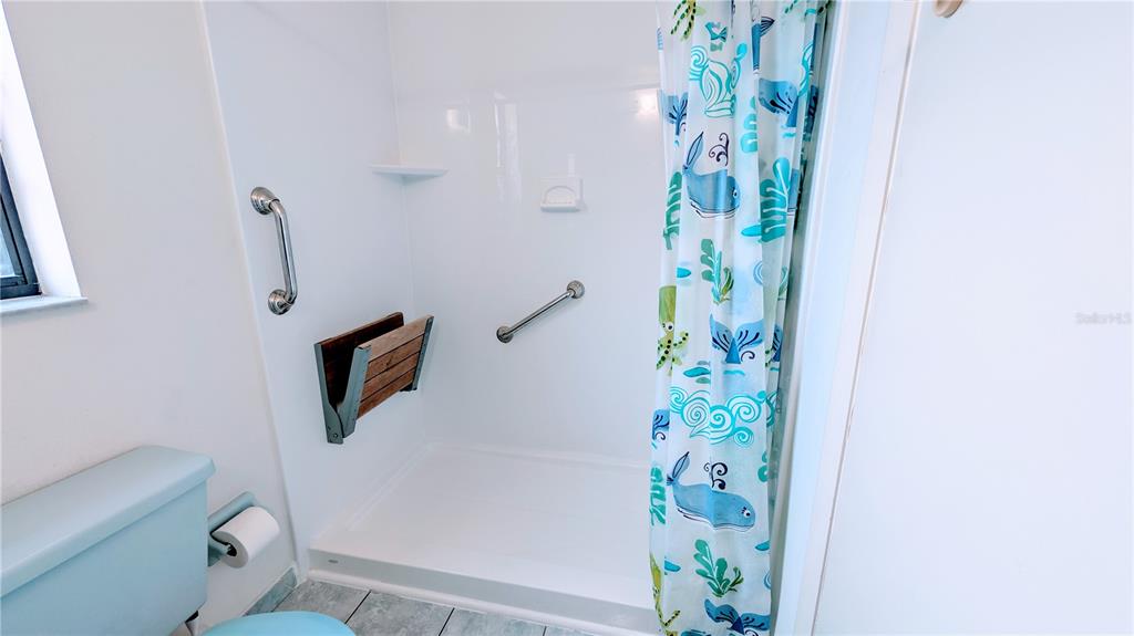 11438 Palomar Street Spring Hill, FL 34609 - Photo 31 of 37 a bathroom with a toilet and a shower curtain