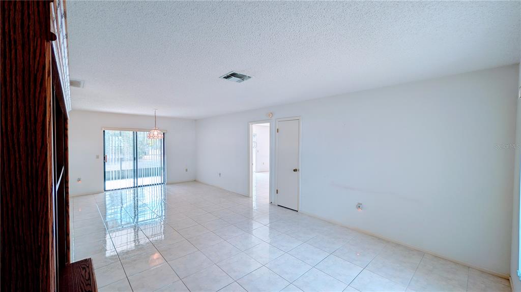 11438 Palomar Street Spring Hill, FL 34609 - Photo 4 of 37 a view of an empty room with a window