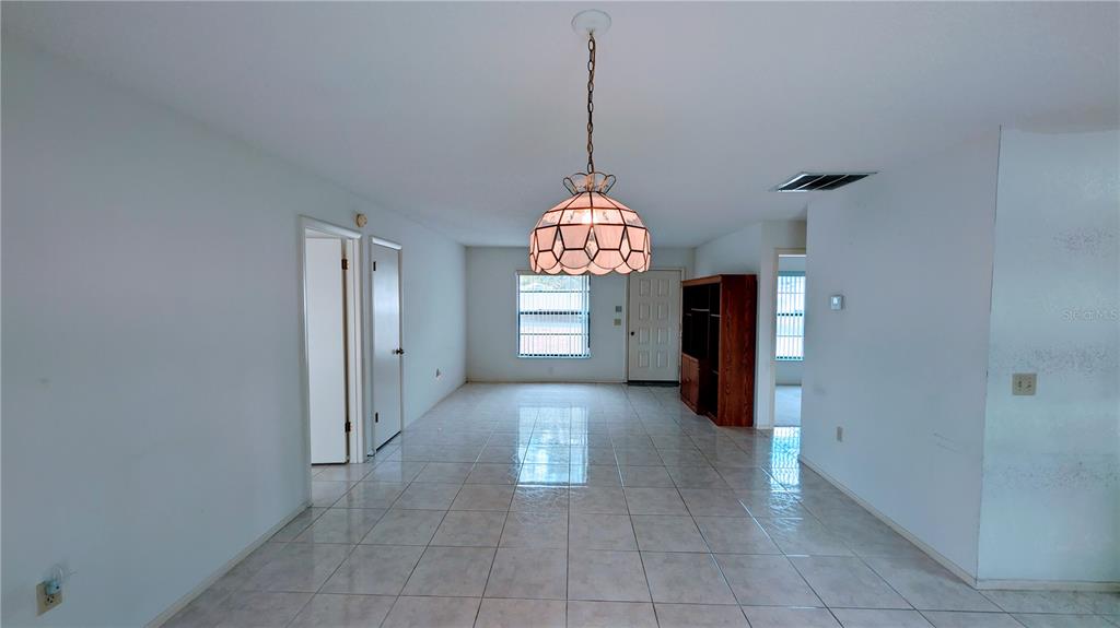 11438 Palomar Street Spring Hill, FL 34609 - Photo 6 of 37 a view of a hallway with windows and chandelier
