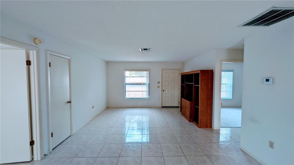 11438 Palomar Street Spring Hill, FL 34609 - Photo 7 of 37 a view of an empty room with a window