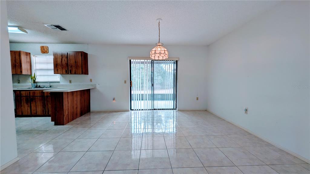 11438 Palomar Street Spring Hill, FL 34609 - Photo 10 of 37 a view of a cabinet and window in a room